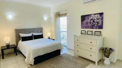 a white bedroom with a bed and a window at Santa Maria C by Check-in Portugal in Albufeira