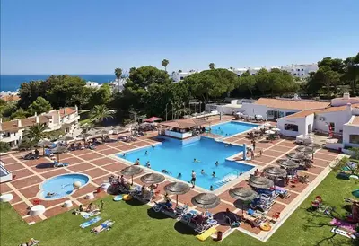 an overhead view of a large swimming pool with people in it at Albufeira Garden in Albufeira