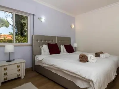 a bedroom with a large bed with towels on it at Vilamoura Golf Mansion by Stay ici Algarve Holiday Rental in Quarteira