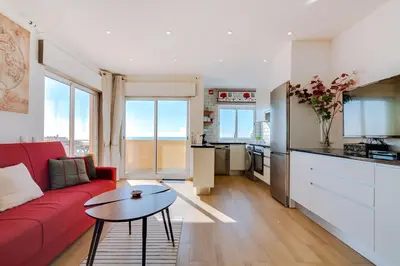 a living room with a red couch and a table at AL - Ocean Wide View in Quarteira