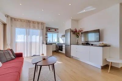 a living room with a red couch and a kitchen at AL - Ocean Wide View in Quarteira
