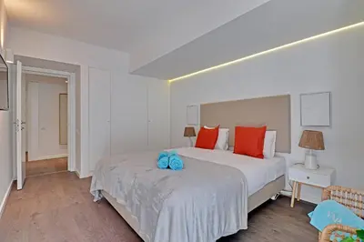 a bedroom with two beds with orange pillows at Home Out Vilamoura 20 Levante in Vilamoura