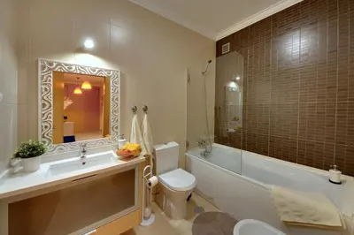 a bathroom with a sink and a toilet and a bath tub at RoofTop OldTown Residence in Albufeira