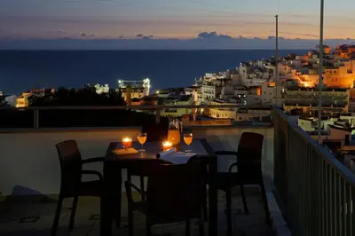 a table on a balcony with a view of the ocean at RoofTop OldTown Residence in Albufeira