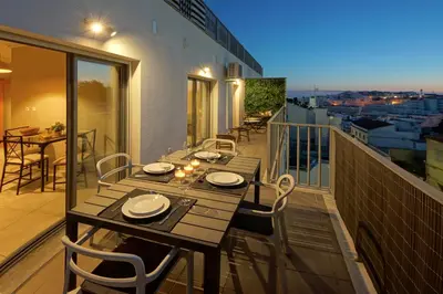 a table and chairs on a balcony with a view at RoofTop OldTown Residence in Albufeira