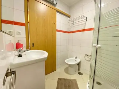 a bathroom with a sink and a toilet at Casa da Bertha in Albufeira