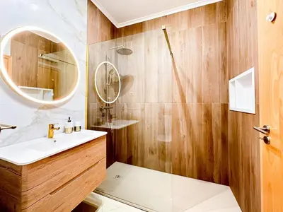 a bathroom with a sink and a shower with a mirror at AlbufeiraOrada Gem by Be Cherish in Albufeira
