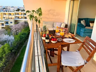 a balcony with a table with food and drinks on it at AlbufeiraOrada Gem by Be Cherish in Albufeira
