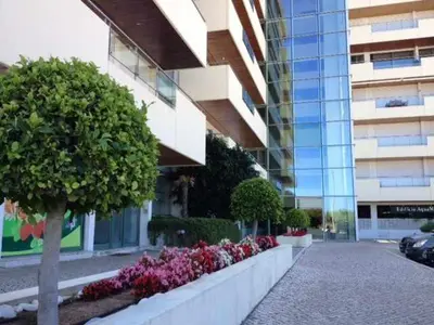 a building with a row of flowers in front of a building at VilamouraSun Aquamar 406 - Vista Marina in Quarteira