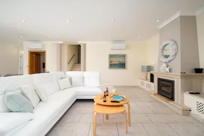 a living room with a white couch and a table at Casa Ch'i - Vale de Lobo in Almancil
