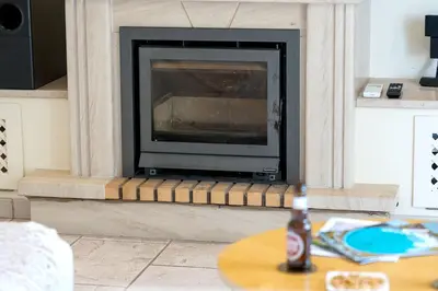 a fireplace with a television in a living room at Casa Ch'i - Vale de Lobo in Almancil