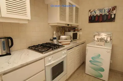 a kitchen with a stove top oven next to a refrigerator at Ocean Dream 84 - Apt. T1 na Praia de São Rafael, Albufeira in Albufeira
