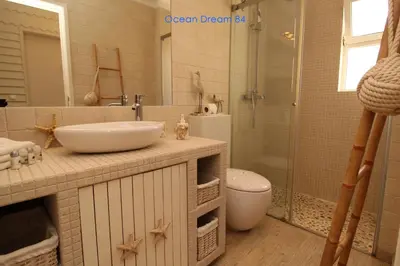 a bathroom with a sink and a toilet and a shower at Ocean Dream 84 - Apt. T1 na Praia de São Rafael, Albufeira in Albufeira