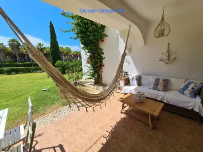 a living room with a couch and a hammock at Ocean Dream 84 - Apt. T1 na Praia de São Rafael, Albufeira in Albufeira
