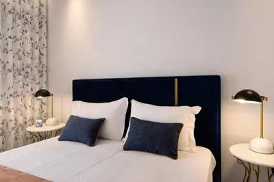 a bedroom with a bed with two tables and two lamps at Apartamento Albufeira Prestige by Sunnyway in Albufeira