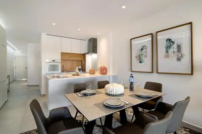 a dining room and kitchen with a table and chairs at Apartamento Albufeira Prestige by Sunnyway in Albufeira