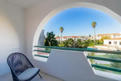 a room with a chair and a window with a view at Apartamento Albufeira Prestige by Sunnyway in Albufeira