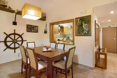 a dining room with a wooden table and chairs at Vilamoura Tenis 58 in Quarteira