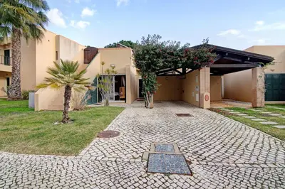 a house with a tree in the yard at Vilamoura Tenis 58 in Quarteira