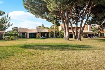a house with a stone path in front of a building at Vilamoura Tenis 58 in Quarteira