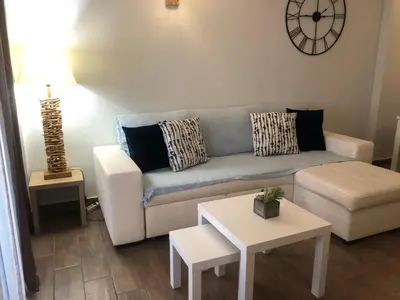 a living room with a table and a couch at Apartamento Oceano in Albufeira