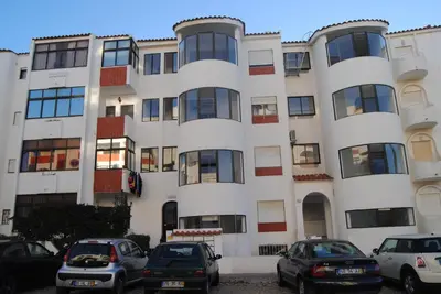 a living room with a couch and a tv at Apartamento Oceano in Albufeira