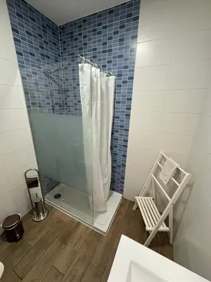 a bedroom with a bed with two lamps on two tables at Apartamento Oceano in Albufeira