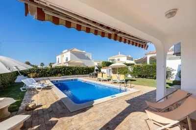 a villa with a swimming pool and a house at Villa dos Netos in Albufeira