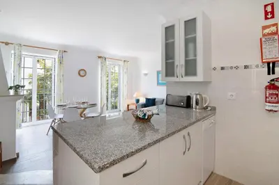 a kitchen with white cabinets and a counter top at Apartamento Old Village T2 Duplex in Quarteira