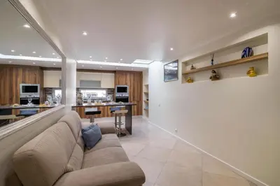 a living room with a couch and a kitchen at Apartamento Malick by Sunnyway in Branqueira