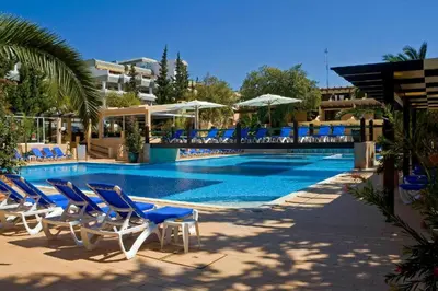 a swimming pool with blue chairs and a swimming pool at Apartamento Malick by Sunnyway in Branqueira