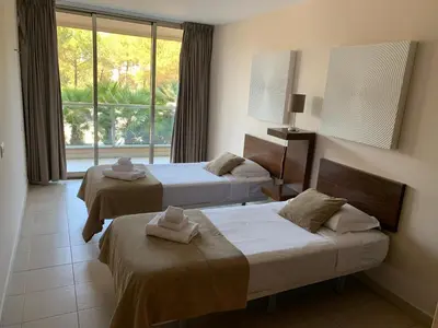 a hotel room with two beds and a window at Salgados - Vila das Lagoas in Guia