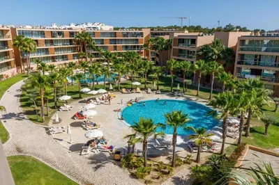an aerial view of a resort pool with palm trees at Salgados - Vila das Lagoas in Guia
