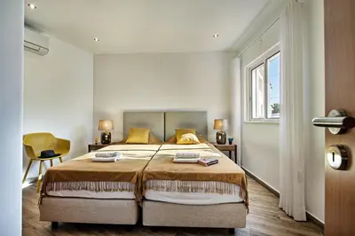 a bedroom with a large bed and a window at Silva by Algarve Villa Holidays in Albufeira