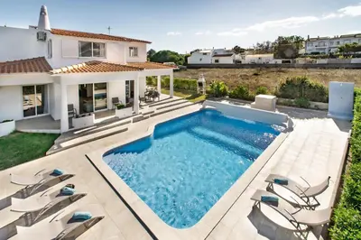 a swimming pool in the backyard of a house at Silva by Algarve Villa Holidays in Albufeira