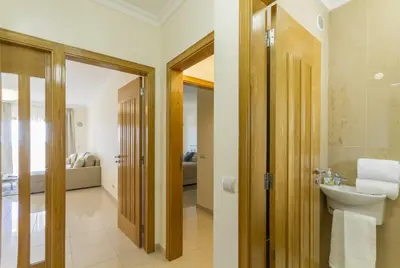 a bathroom with a toilet and a sink in a room at Millennium Plaza in Vilamoura