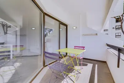 a dining room with a yellow table and purple chairs at Ténis Studio Apartment - Vilamoura in Vilamoura