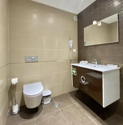 a bathroom with a toilet and a sink and a mirror at Ténis Studio Apartment - Vilamoura in Vilamoura