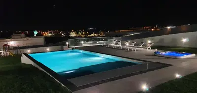 a swimming pool with lounge chairs next to a pool at Sunrise Villa by Laranjal Rentals in Albufeira