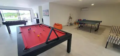 a pool table in a living room with a ping pong ball at Sky Villa by Laranjal Rentals in Albufeira