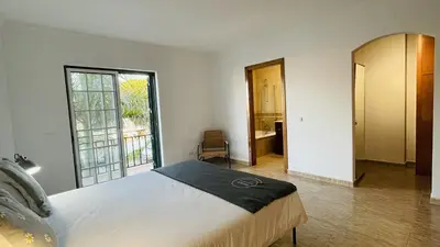 a bedroom with a large bed and a large window at Mosqueira by Check-in Portugal in Albufeira