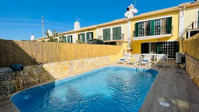 a swimming pool in front of a house at Mosqueira by Check-in Portugal in Albufeira