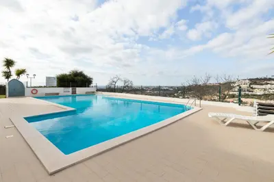 a swimming pool on the roof of a building at Apartment Marina in Albufeira