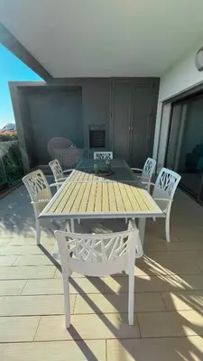 a wooden table and chairs on a patio at Alvorada Premium by Sunny Deluxe in Albufeira