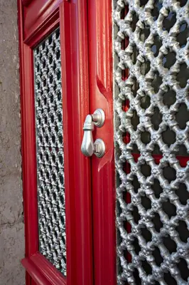 a red door with a window on it at Casa da Vila in Faro