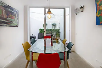a dining room with a glass table and chairs at Casa da Vila in Faro