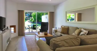 a living room with a couch and a tv at Victory Village 20B in Quinta do Lago
