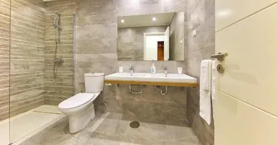 a bathroom with a toilet and a sink and a shower at Victory Village 20B in Quinta do Lago