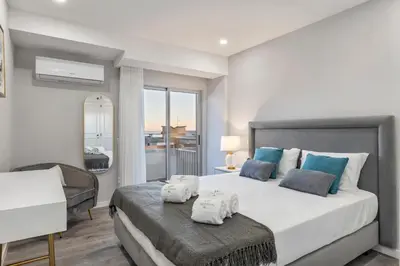 a bedroom with a large bed with towels on it at Faro Main Avenue Apartment in Faro