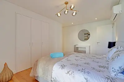 a bedroom with a bed and a chandelier at Dubai Apartment in Vilamoura